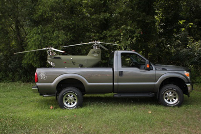 The DP-12 is designed to fit in and land/launch from standard vehicles, such as the bed of a pickup truck or humvee, or small utility trailer.  The rotor blades can be removed and/or installed in about 5 minutes for transport.